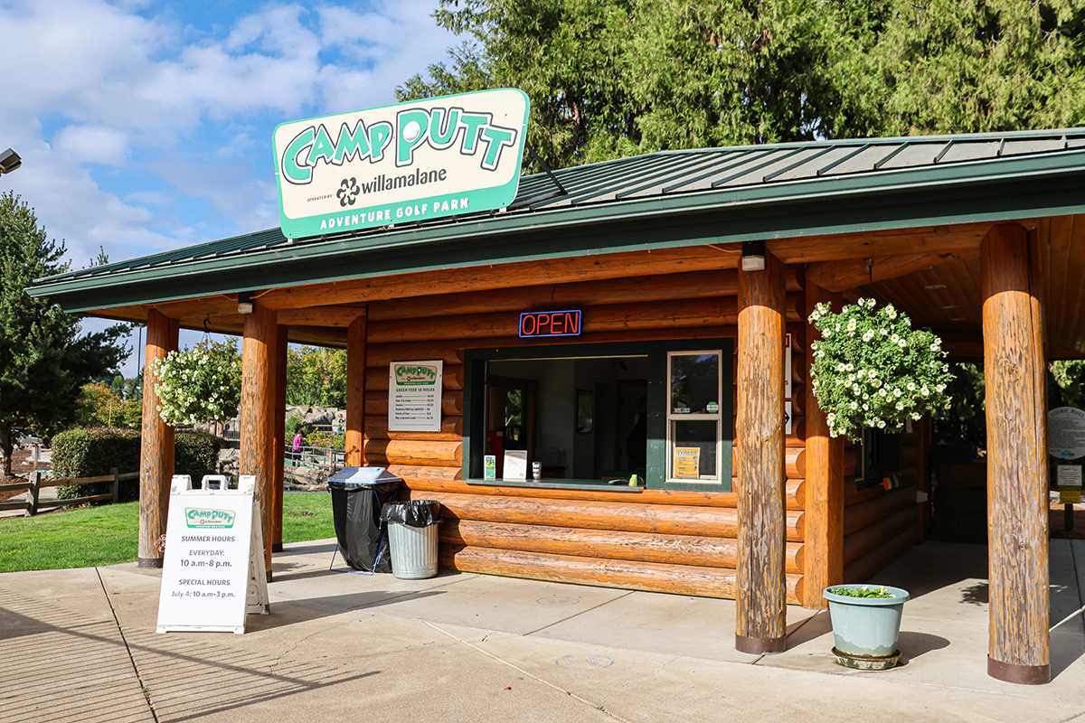 Exterior view of Camp Putt log cabin check in station