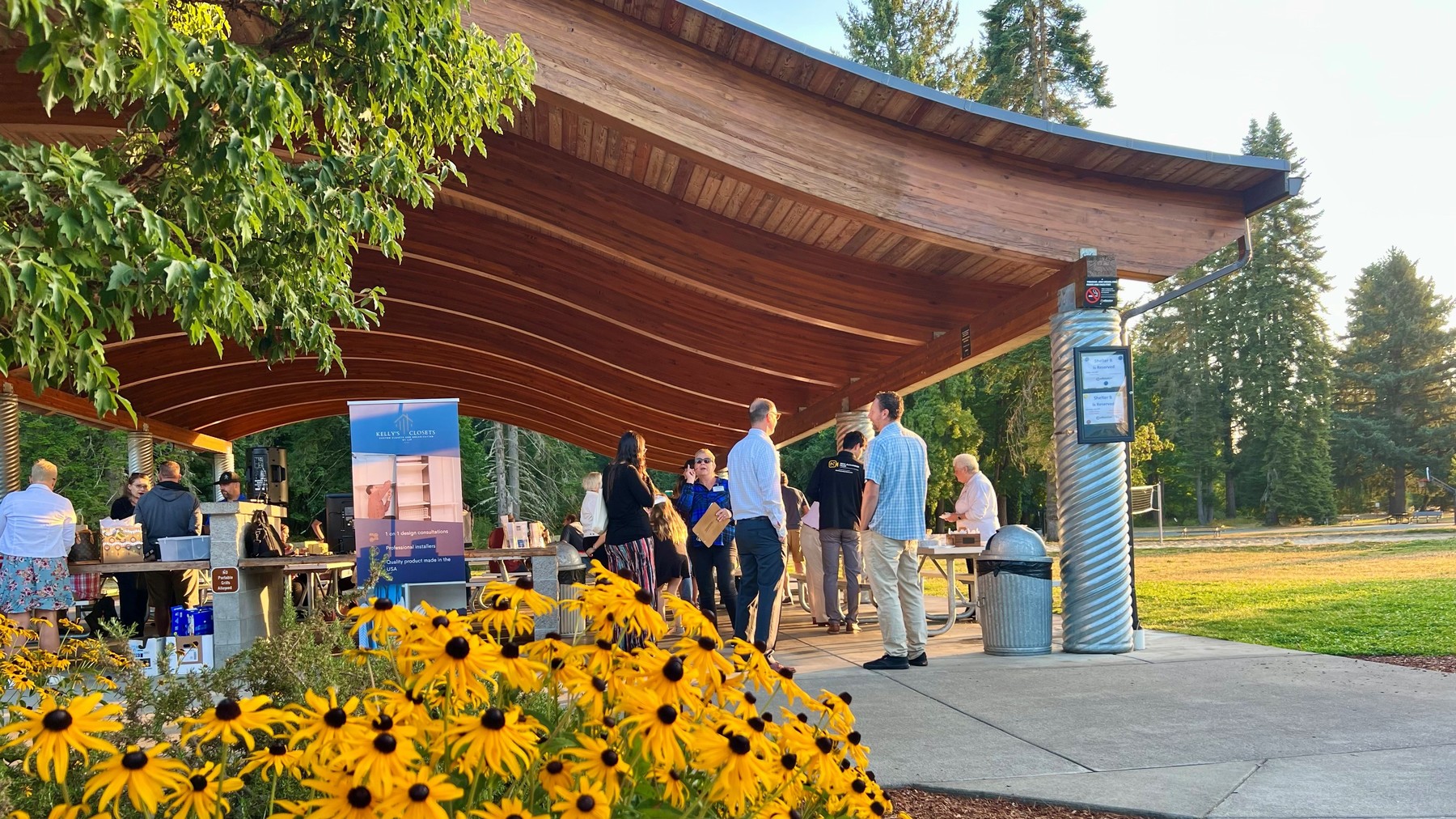 A local business event takes place in outdoor shelters on a sunny morning