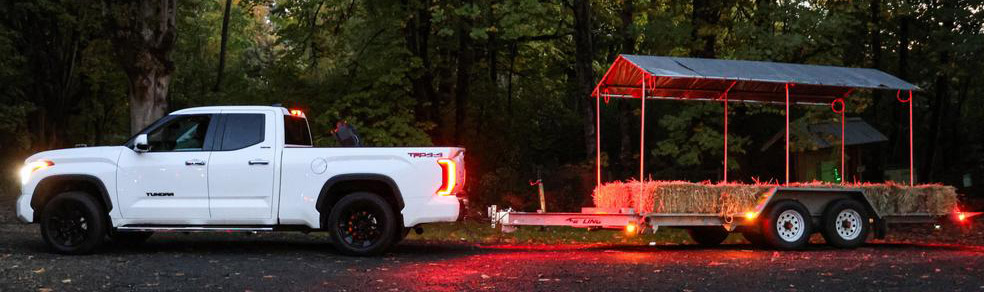 A Toyota truck pulls a hayride trailer at Haunted Hayride