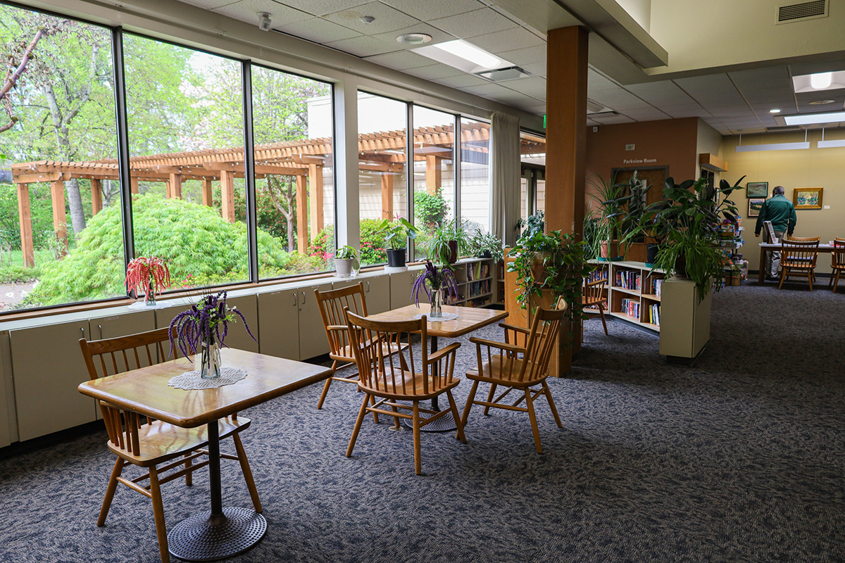 Small table and chairs line windows inside Willamalane Adult Activity Center