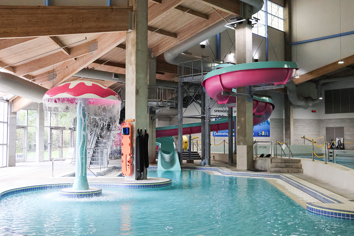 A pink and teal waterslide and jellyfish at Splash