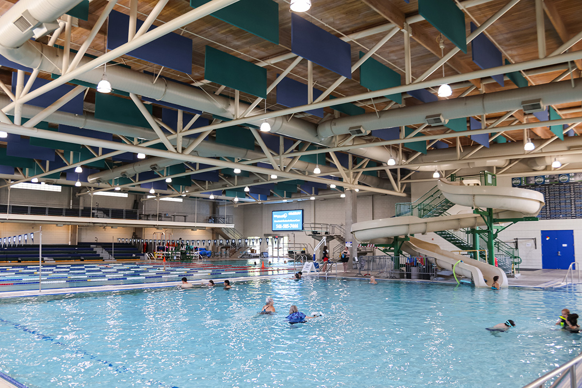 A few people swim in the warm shallow pool at Willamalane Park Swim Center