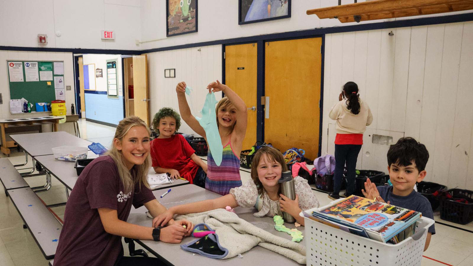 Staff sits with students at after school program at school