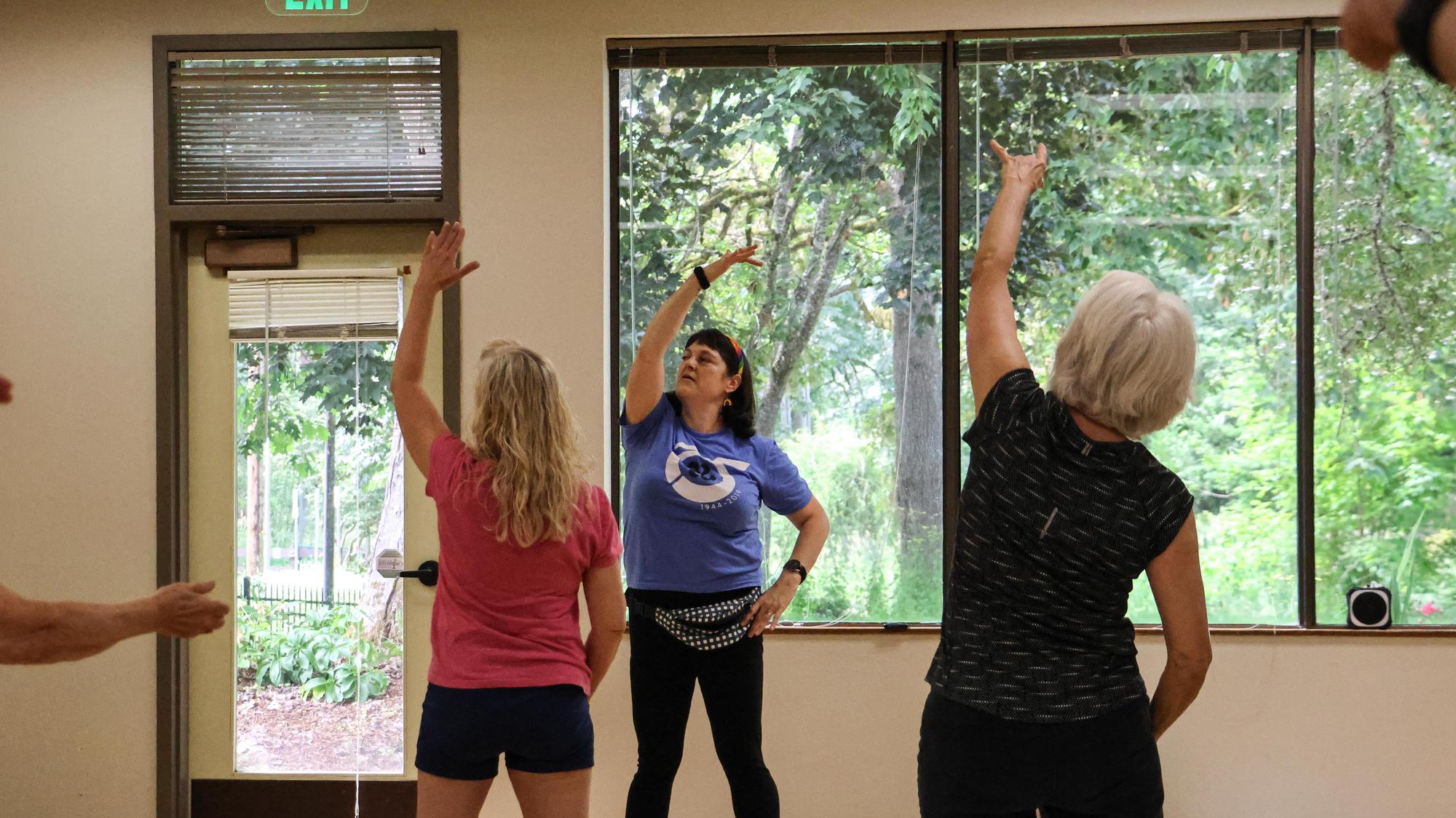 Participants in a fitness class stretch