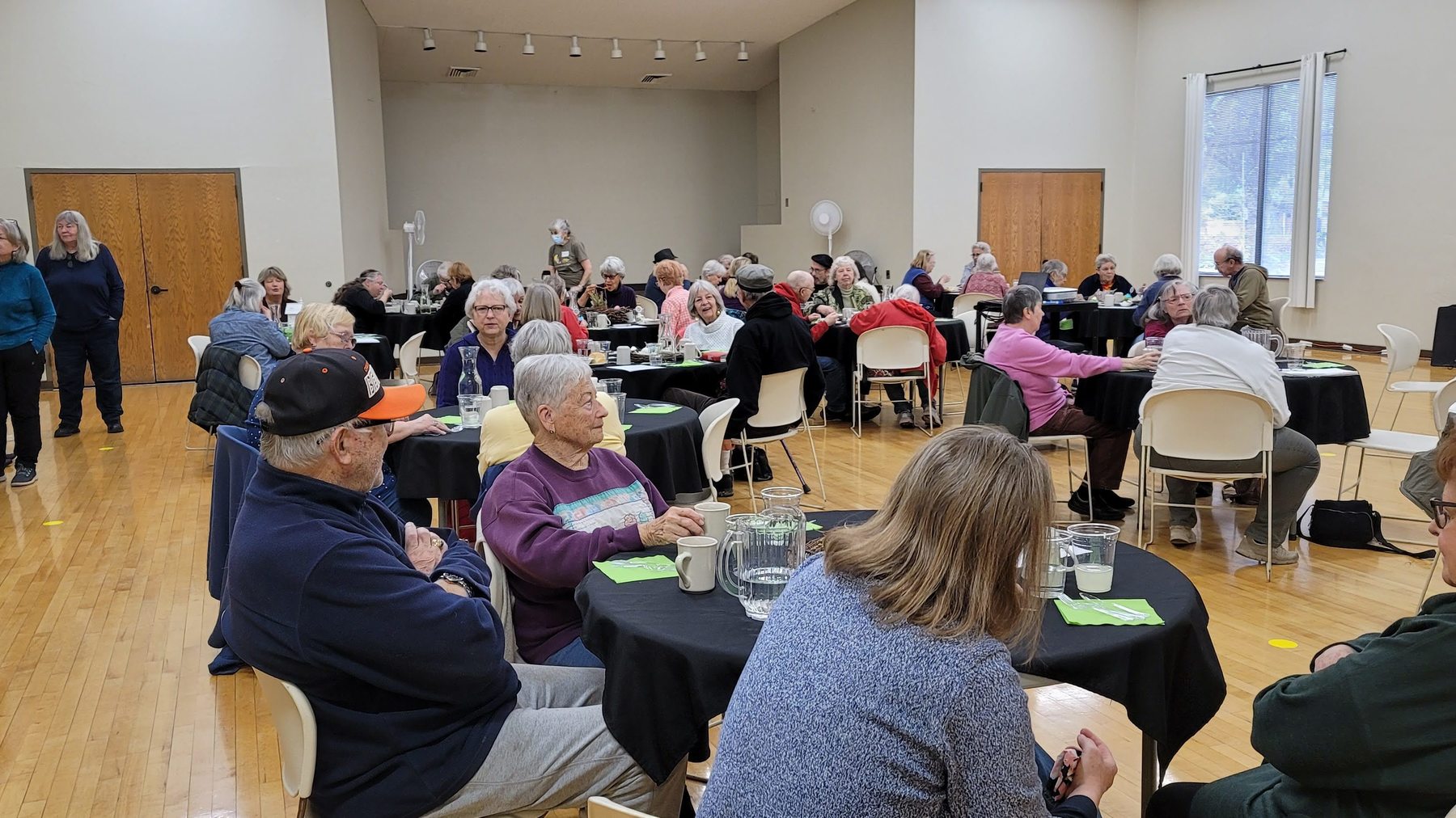 community members socialize around tables at Willamalane Adult Activity Center