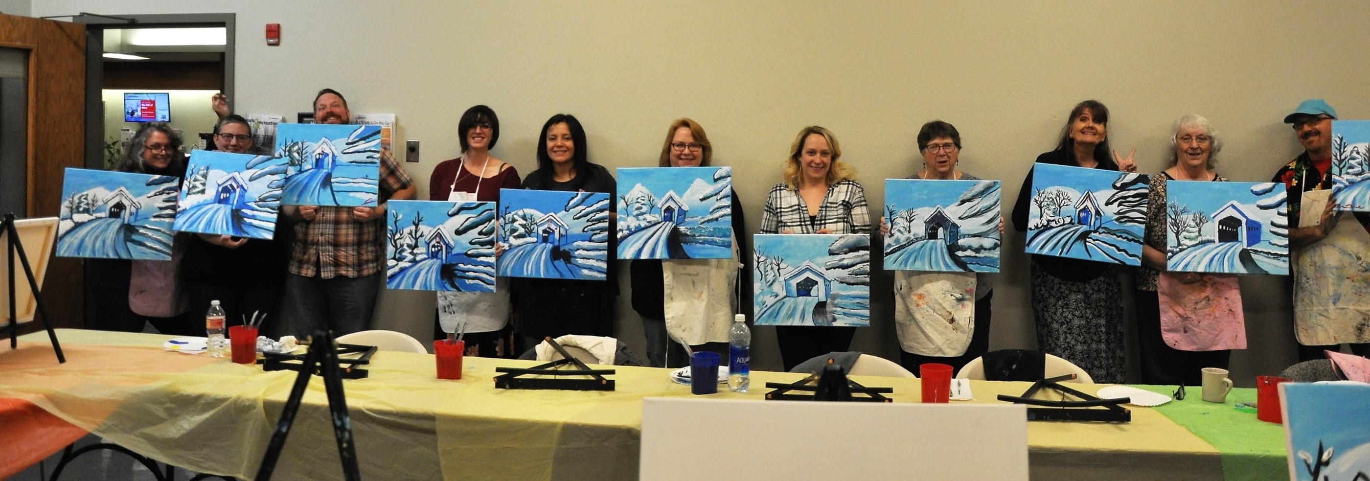 Group takes photos with their paintings