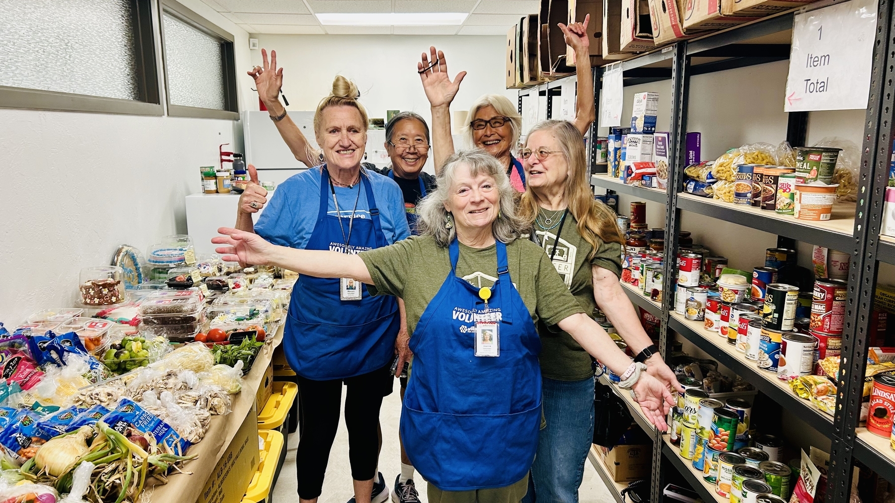 Volunteers celebrate donations in the food pantry