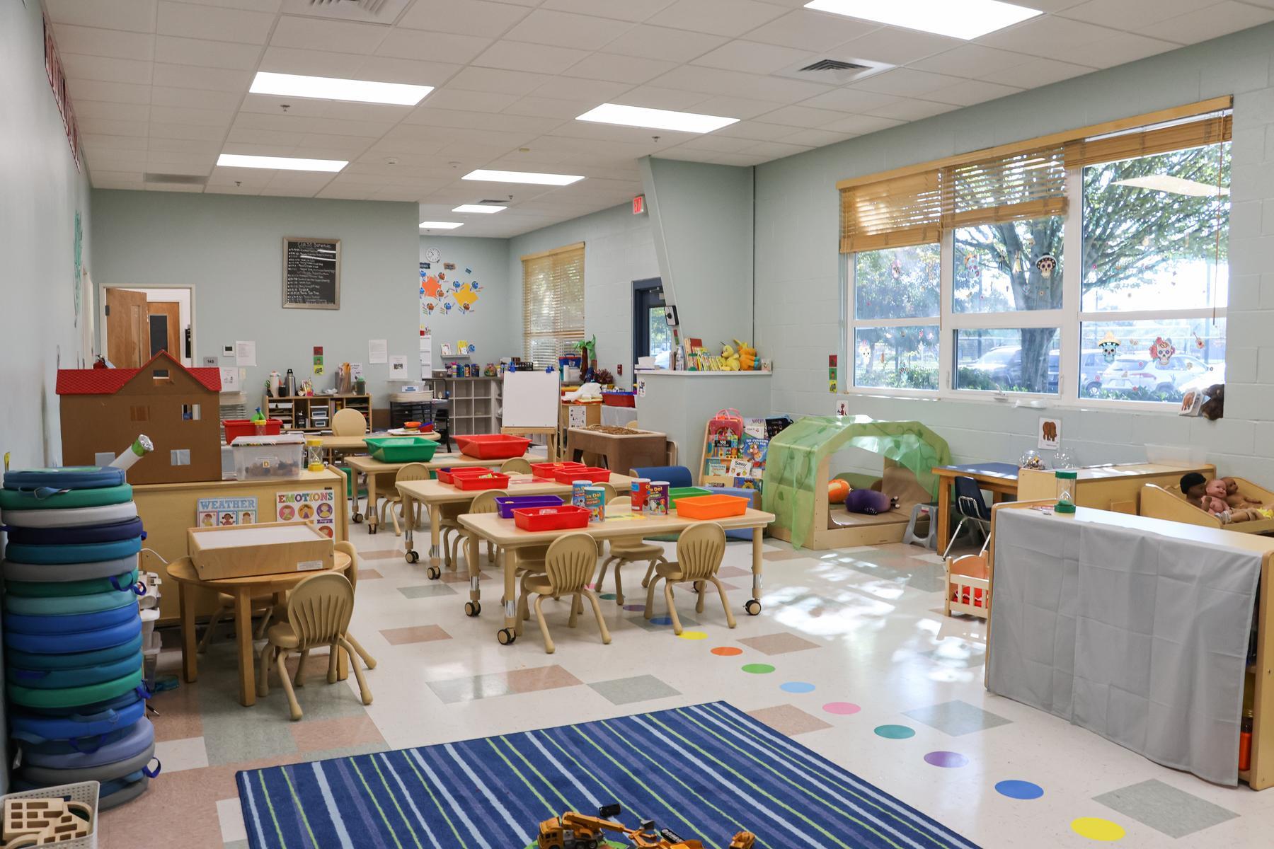 A classroom features new furniture in a bright, welcoming space