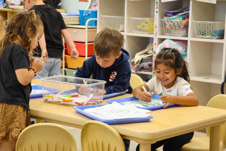 Preschoolers enjoy activity at a workstation