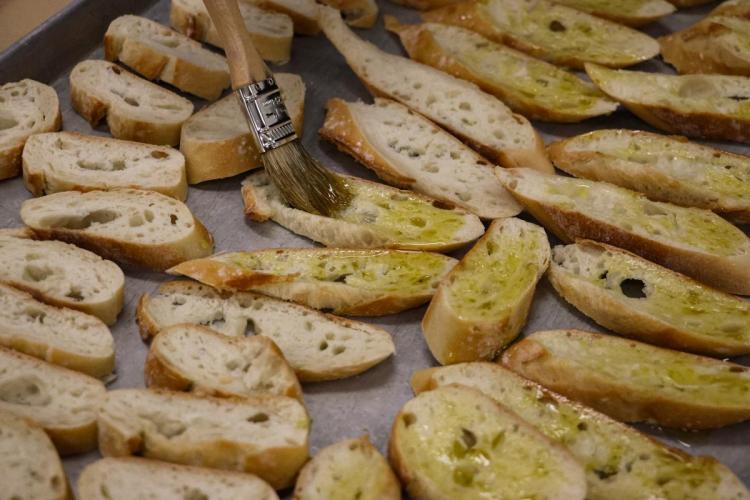 Bread brushed with olive oil on a pan