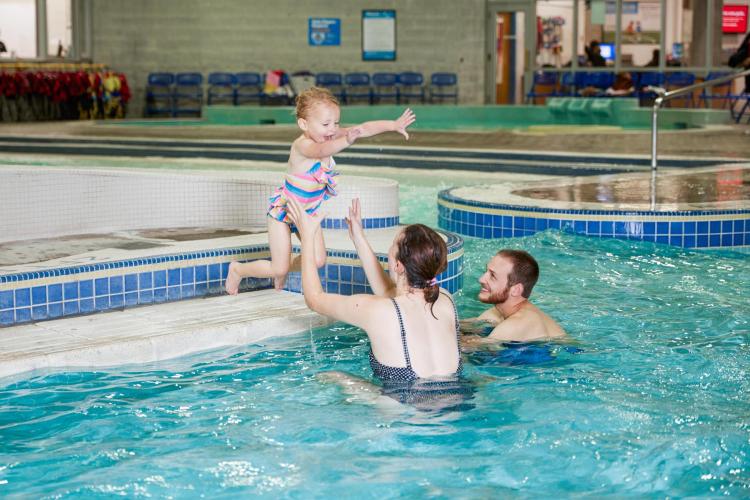 Parents catch child practicing jumping into the pool at Splash