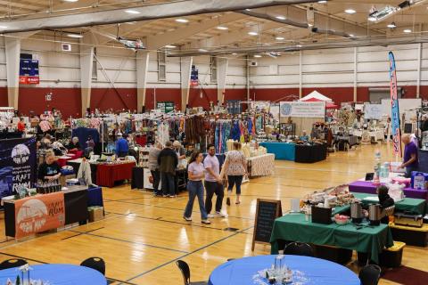colorful booths line the floor with a variety of handcrafted goods.