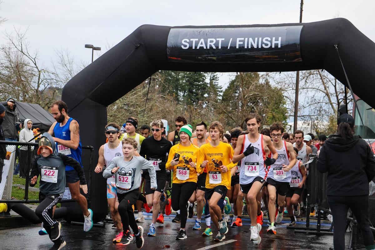 Participants running under the start line for a 5k