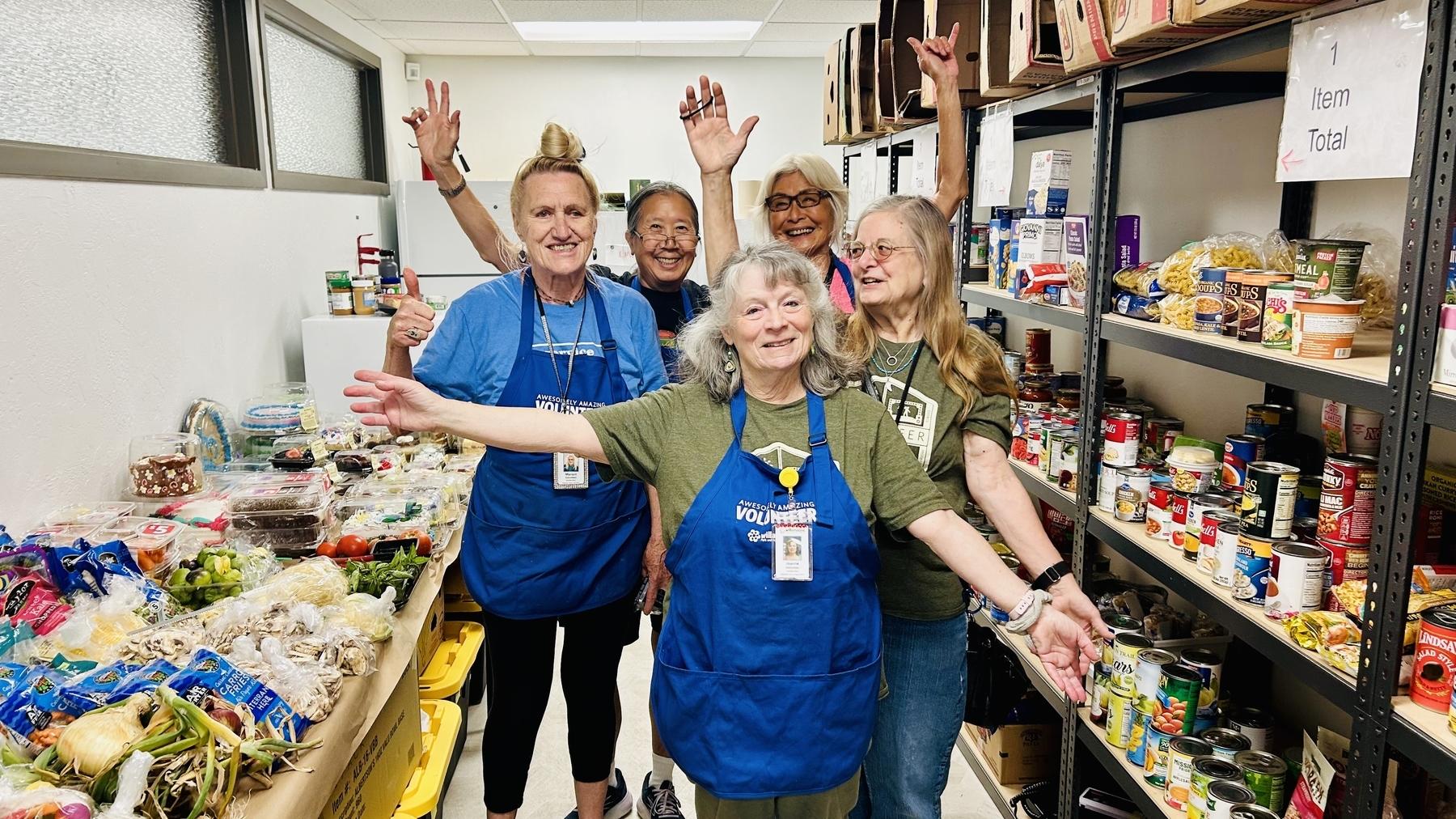 Volunteers celebrate donations in the food pantry