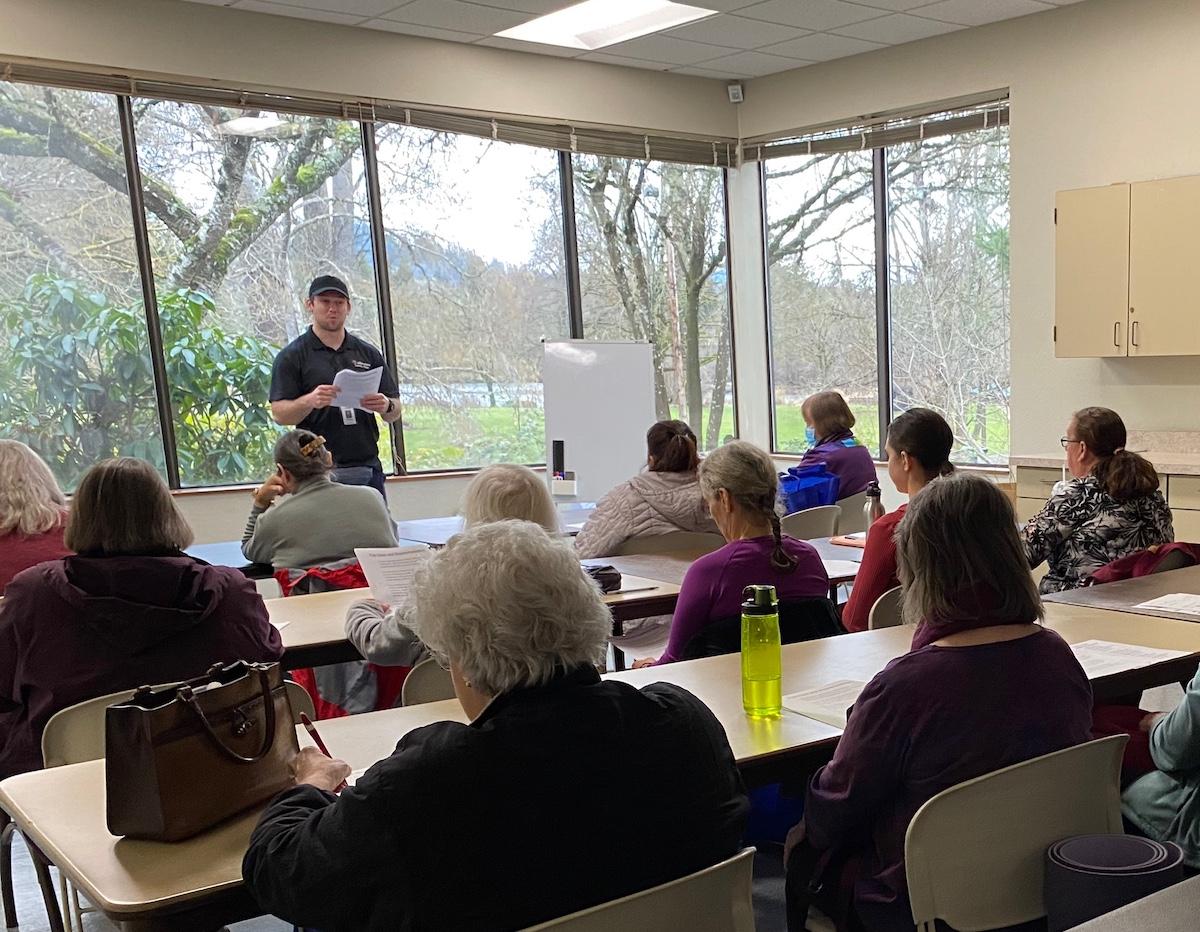 A class of learners watches an instructor.
