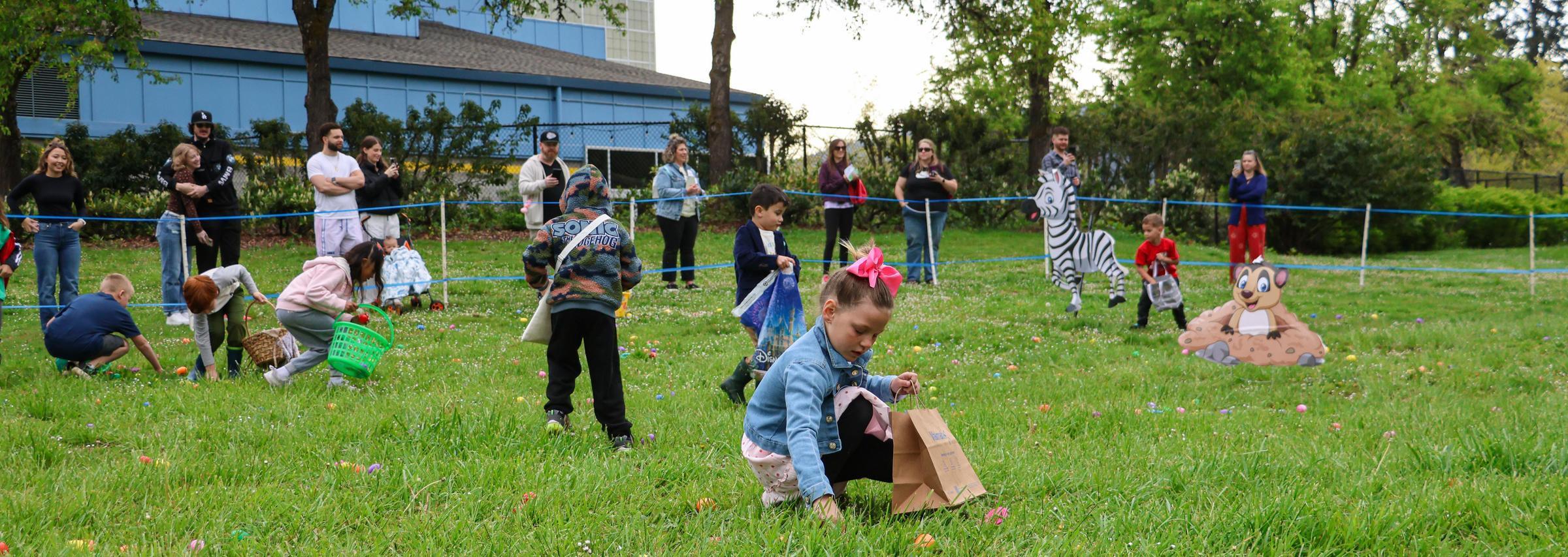 Kids pickup eggs in outdoor hunt