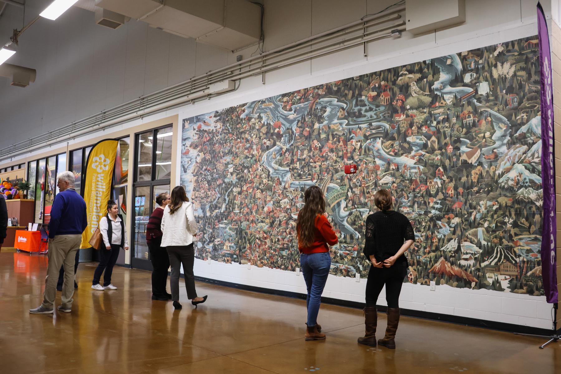 Community members view 25-foot mural in Bob Keefer Center's lobby