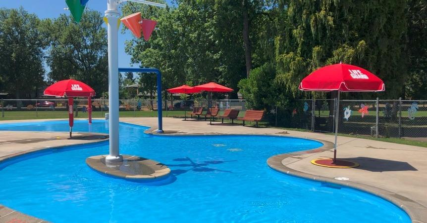 An outdoor shallow pool with water play features