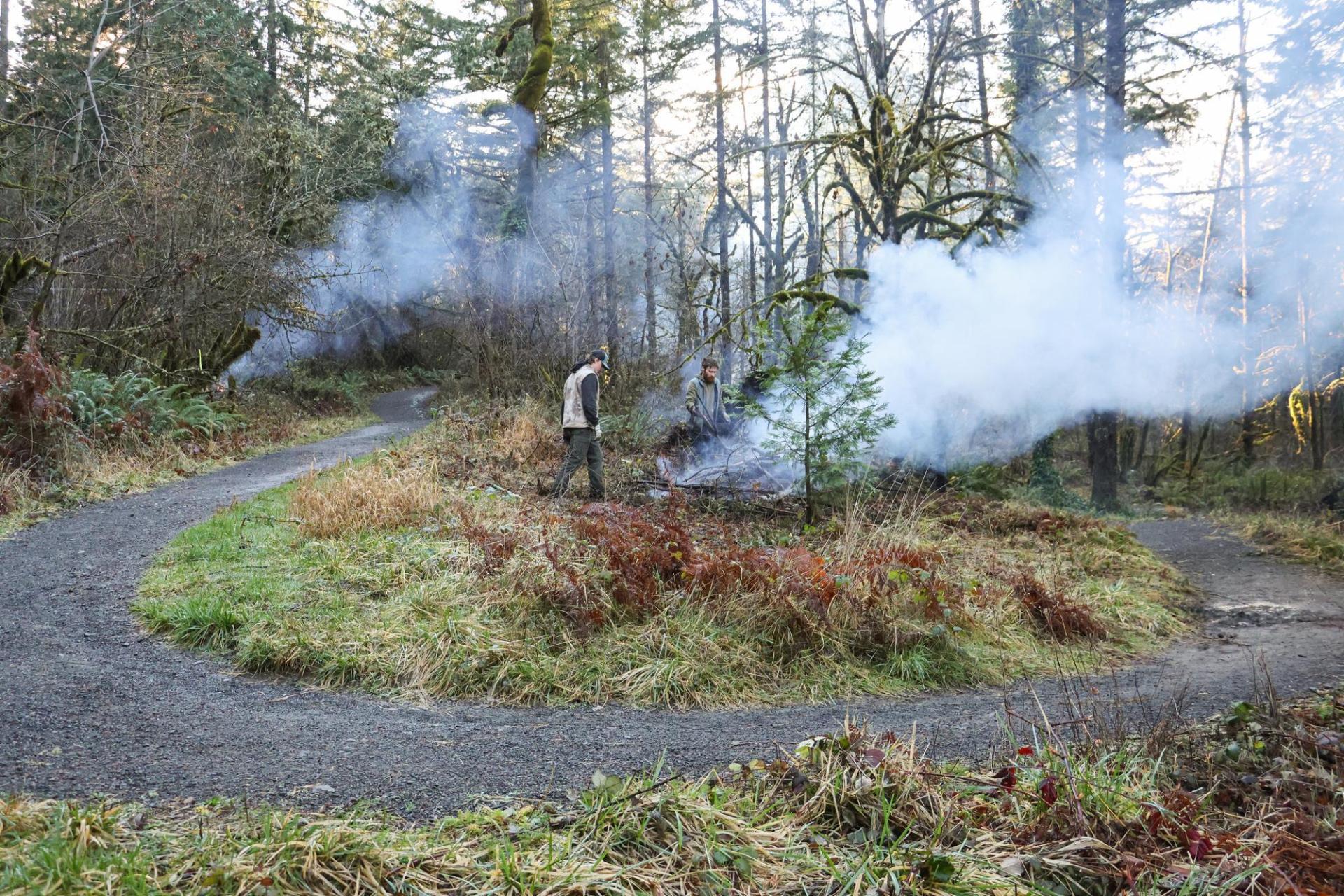 Crews tending to a burn pile at Thurston Hills