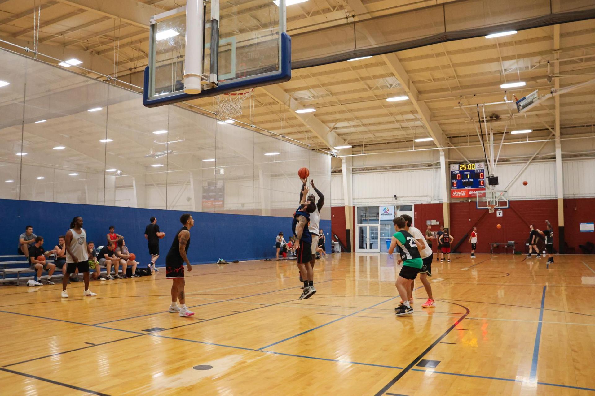 adult rec basketball on wood courts