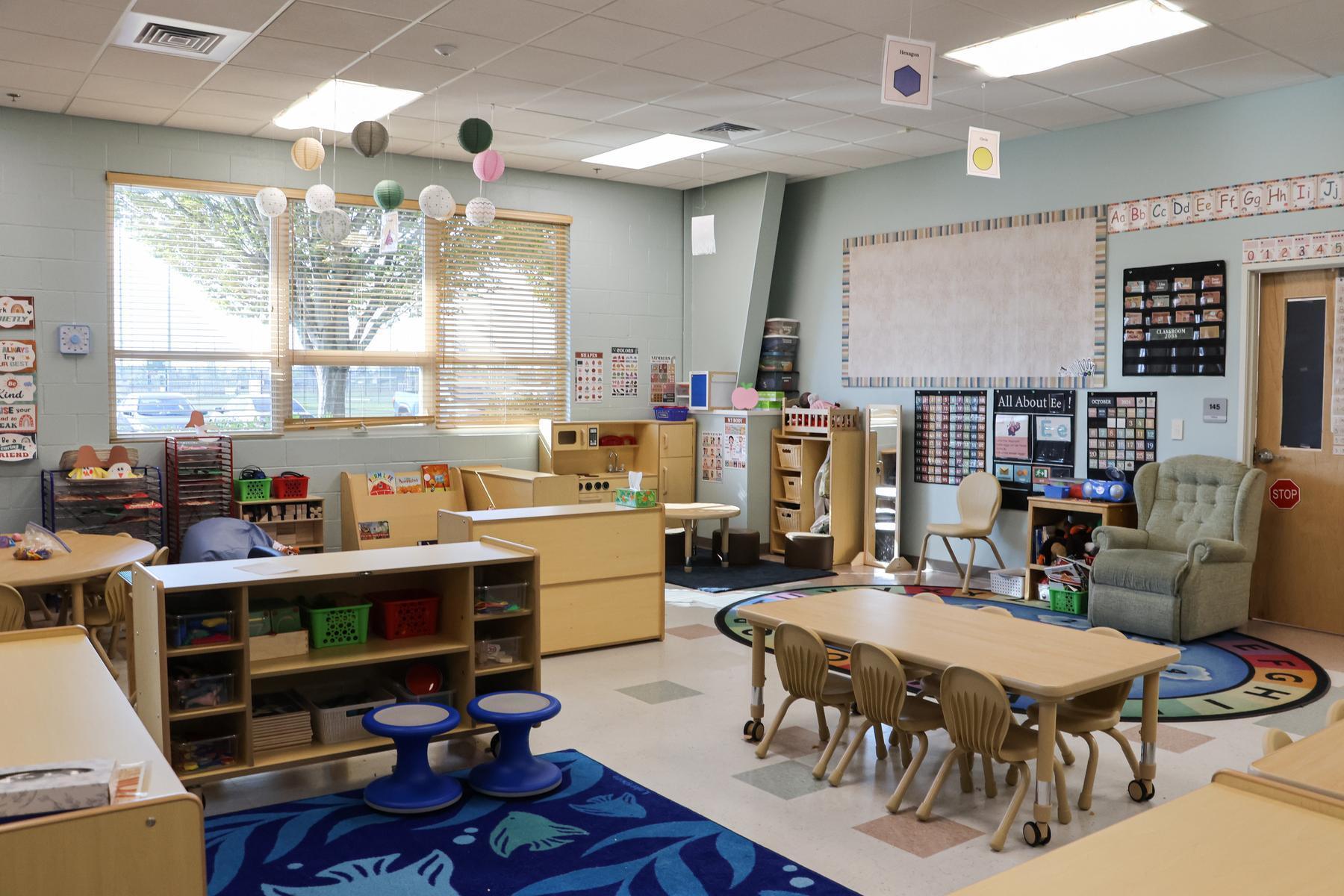 A classroom features new furniture in a bright, welcoming space