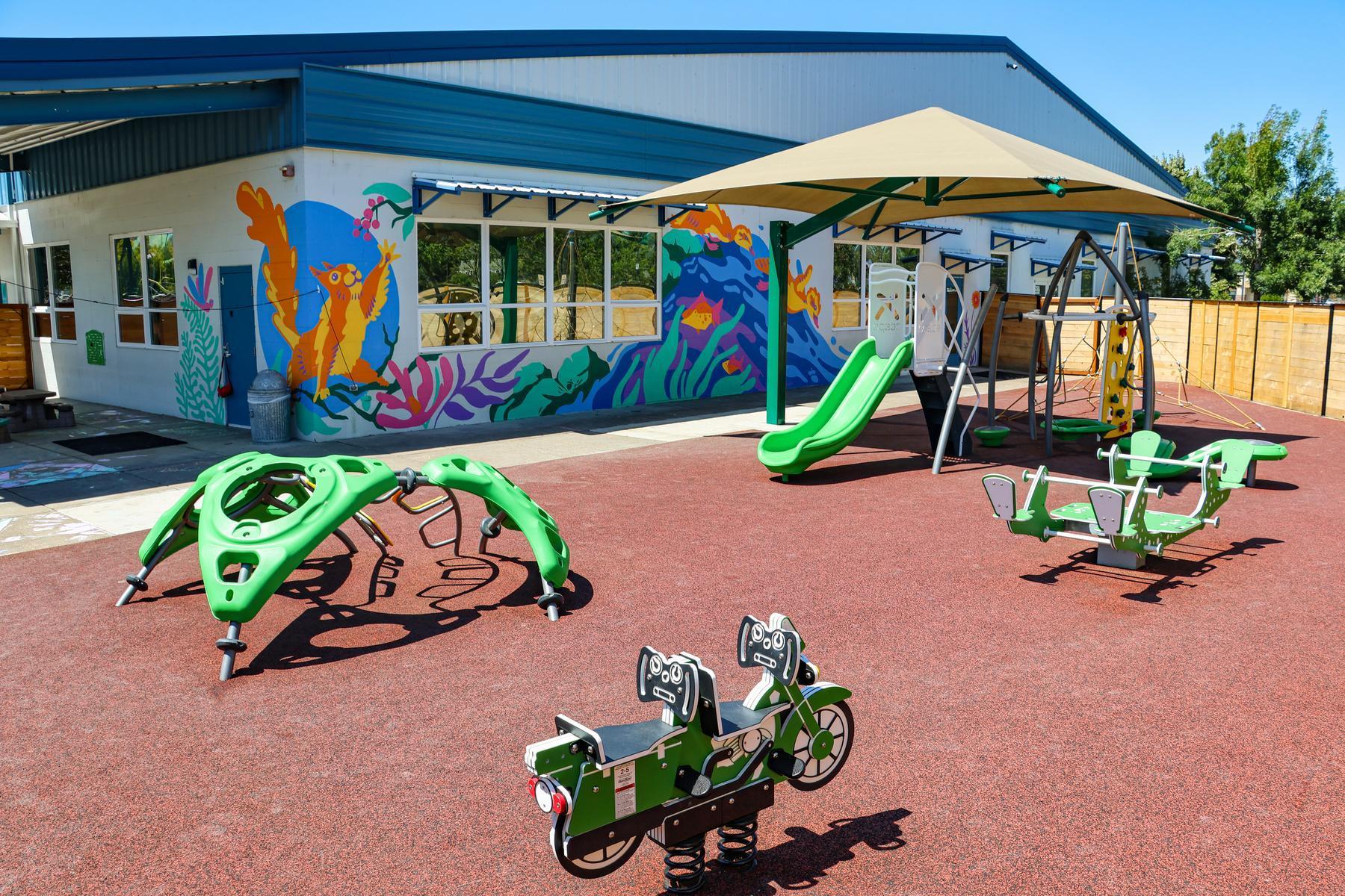The Tiny Ducks Preschool playground features new equipment, soft-surfaces, and a colorful mural