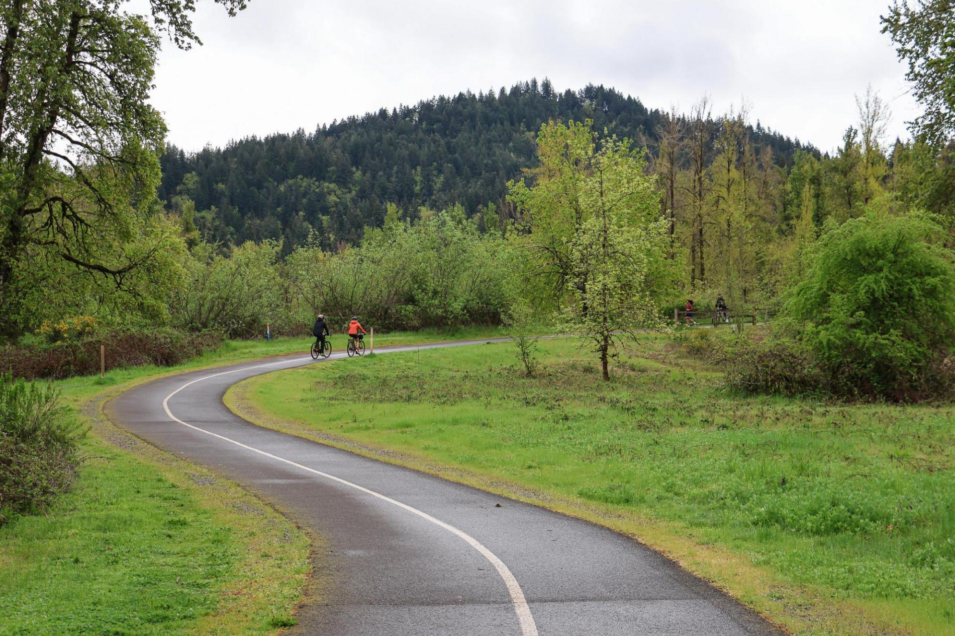 Paved Mill Race Path with bikers during spring