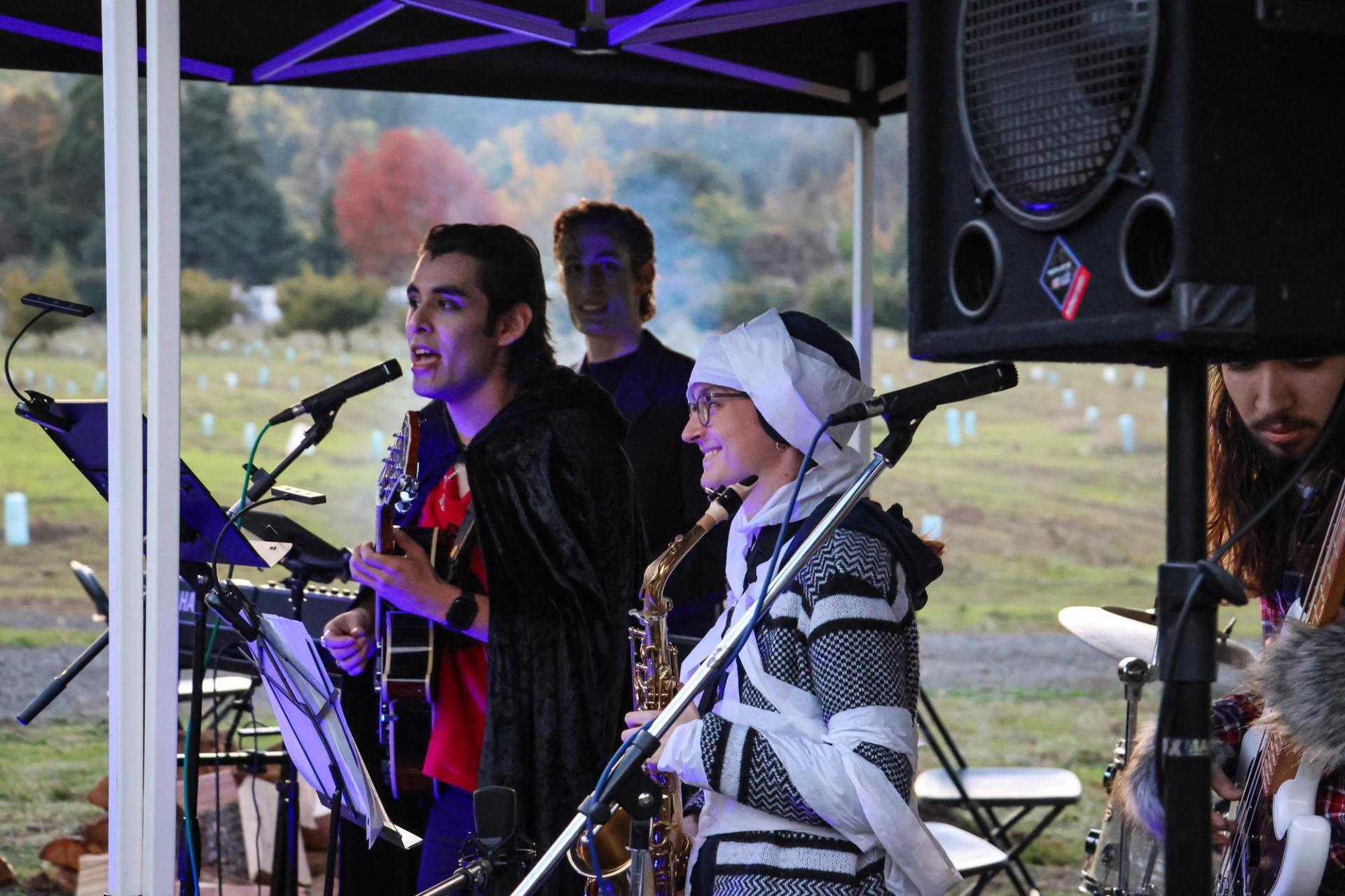 band members playing instruments dressed in Halloween costumes