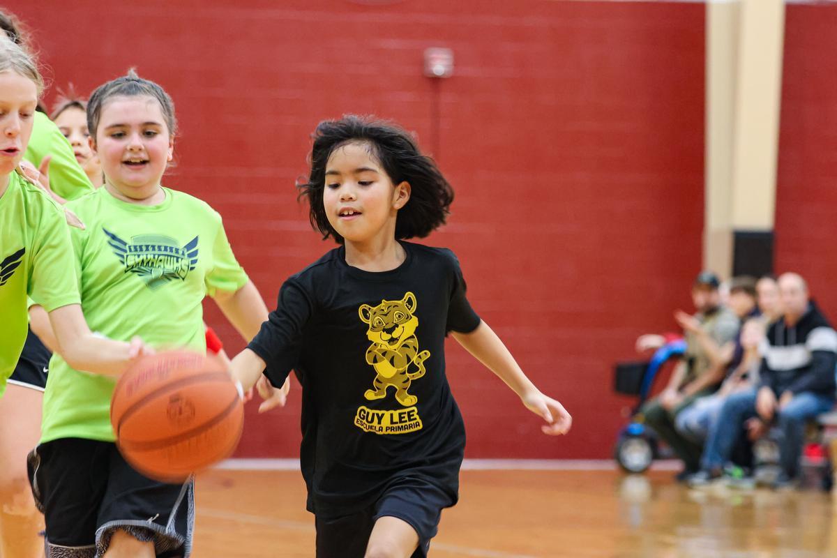 Youth basketball player dribbling down the court