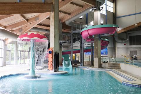 A pink and teal waterslide and jellyfish at Splash